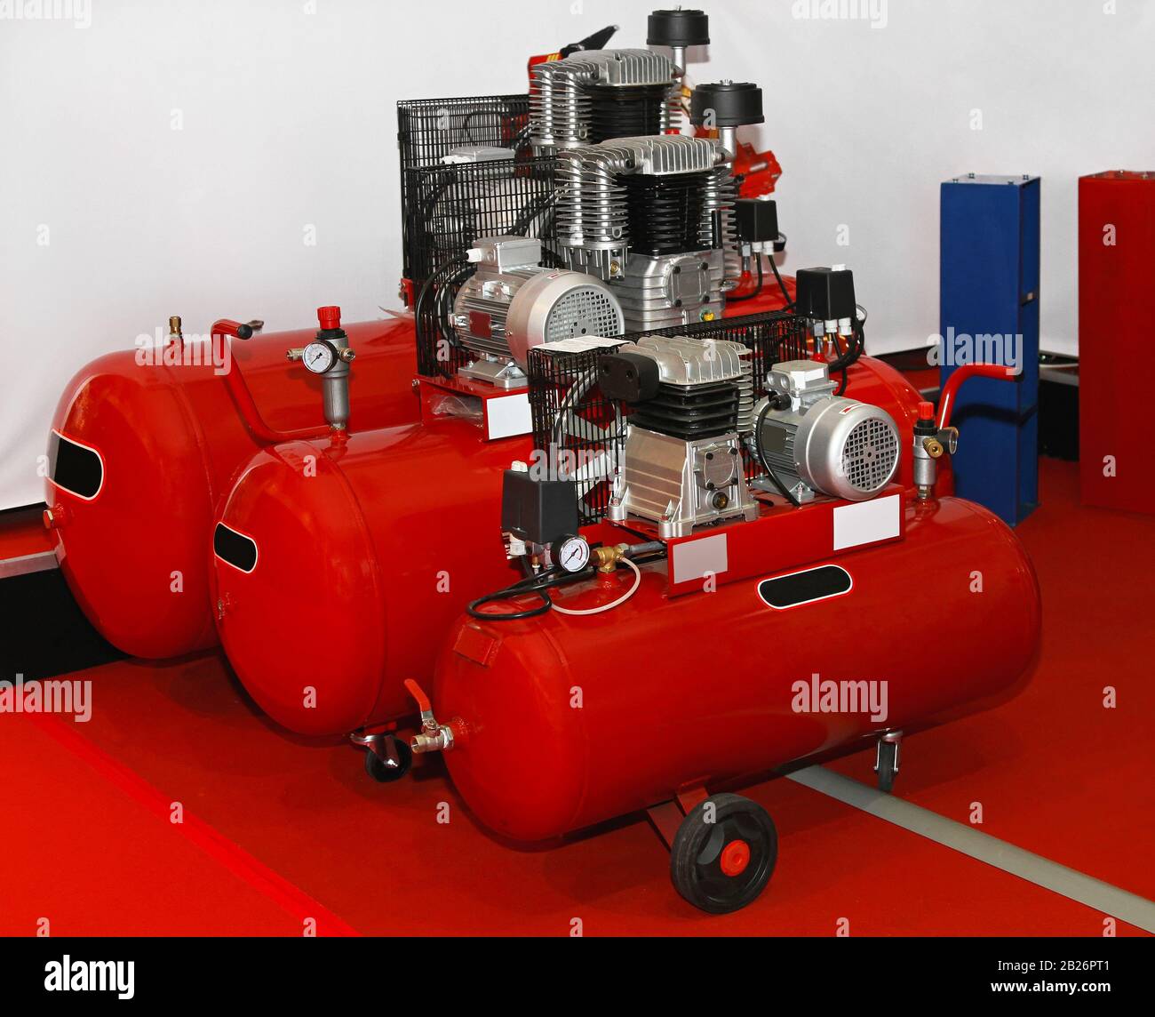 Three air compressors for auto service garage Stock Photo Alamy