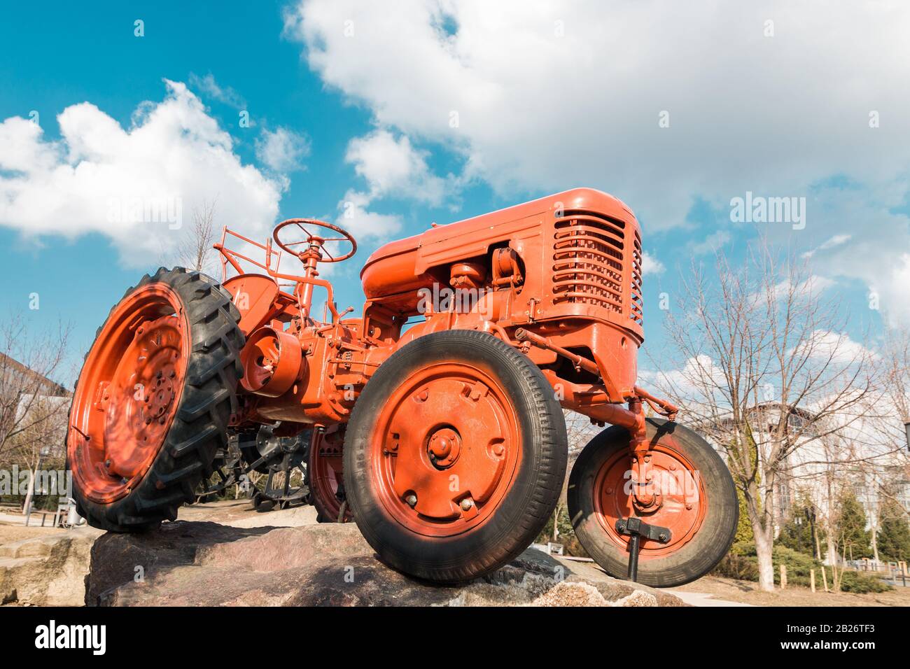 old red tractor on farm over blue sky with clouds Stock Photo - Alamy