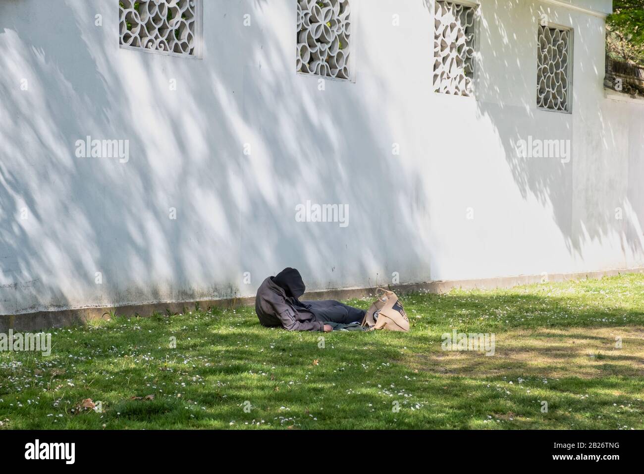 VANCOUVER - MAY 05 2019: Chinatown, Vancouver Canada. Homeless people sleeping on grass. Stock Photo