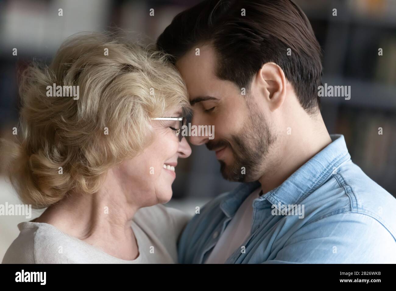 Happy mature mother and adult son enjoy close family moment Stock Photo
