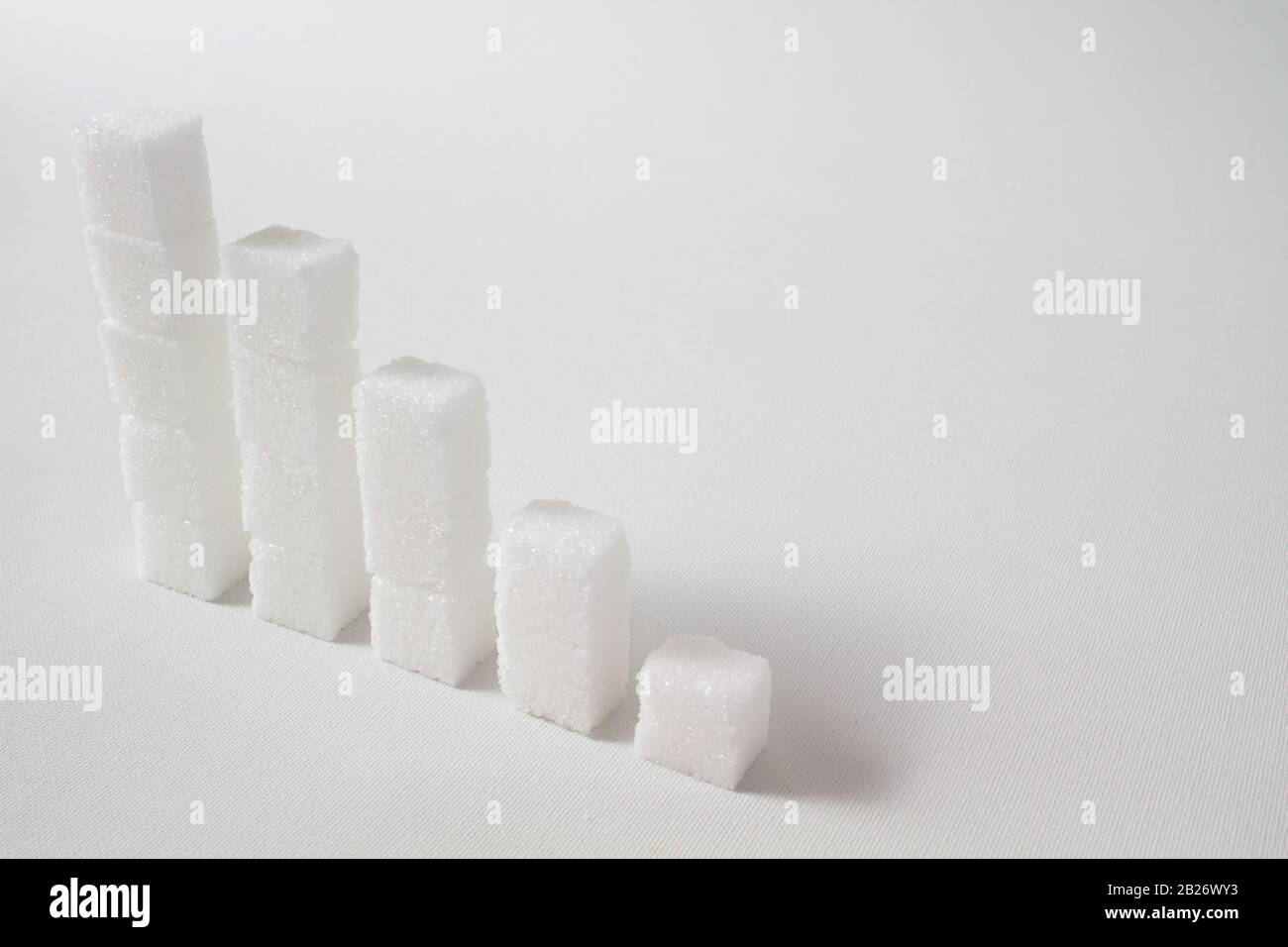 high key of five collumns made of sugar cubes with decreasing height