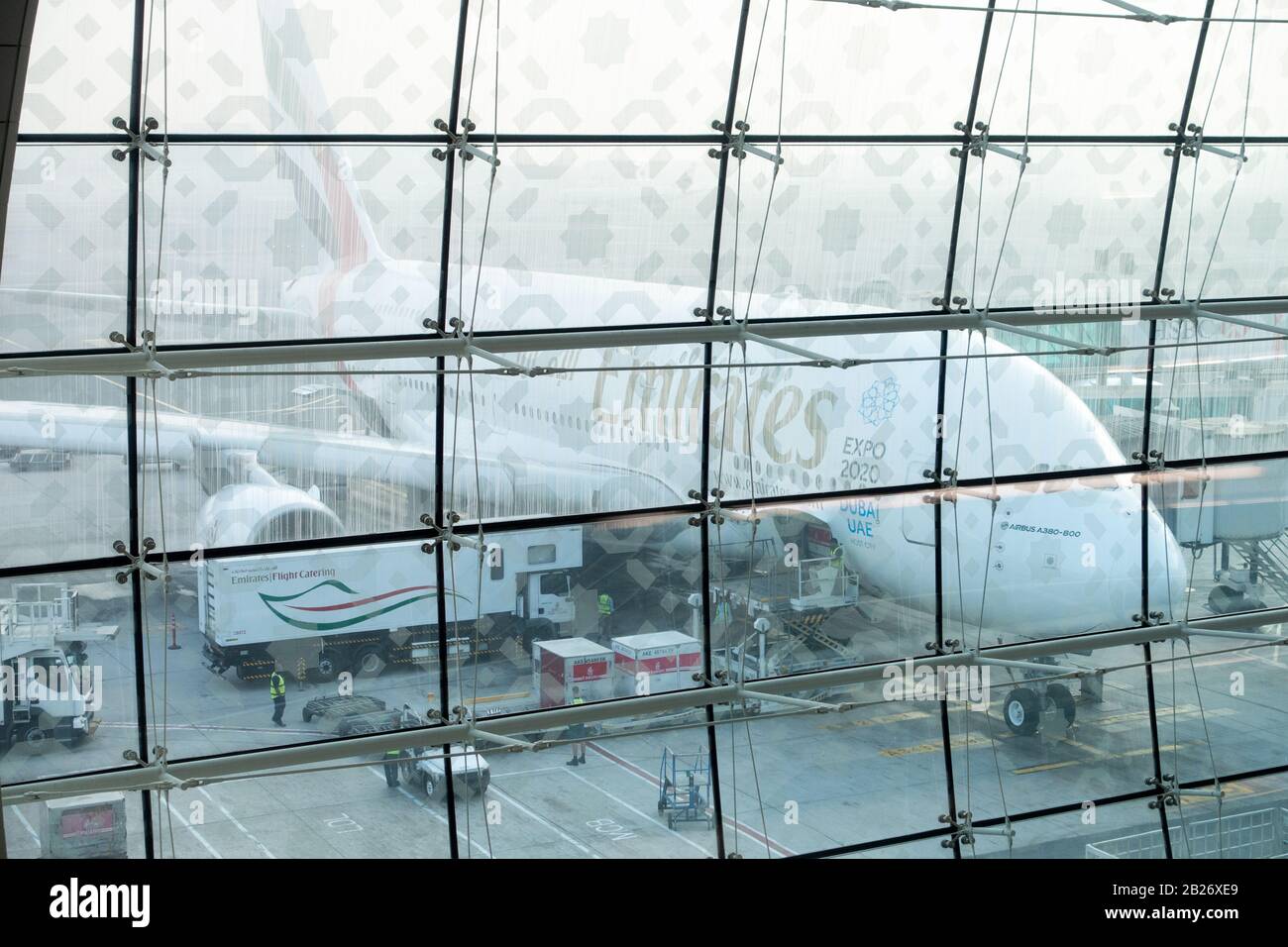 Emirates Air Bus A380 at Dubai International Airport terminal seen through the glass wall of the departure terminal Stock Photo