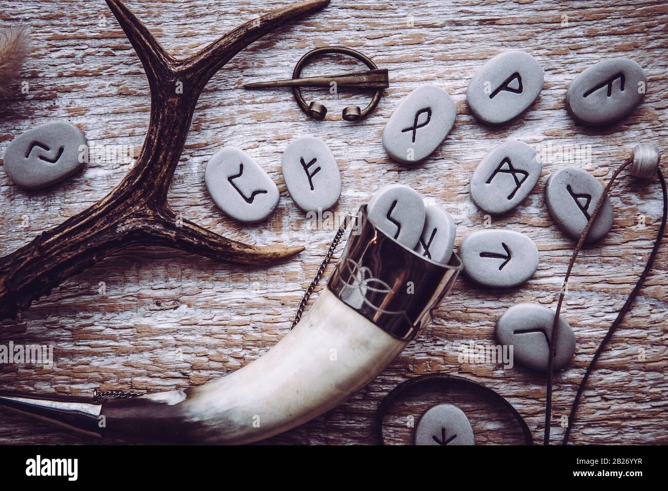 Flat lay view of rune stones with various viking era style objects. Ancient divination and vikings lifestyle concept. Stock Photo