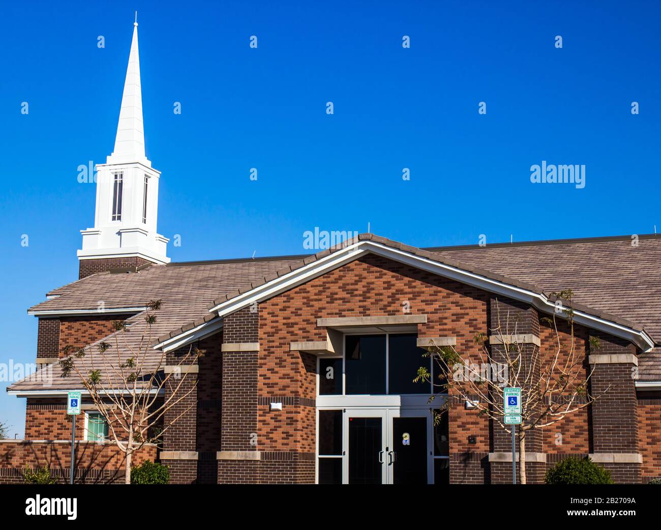 Entry To Local Neighborhood Church With White Steeple Stock Photo