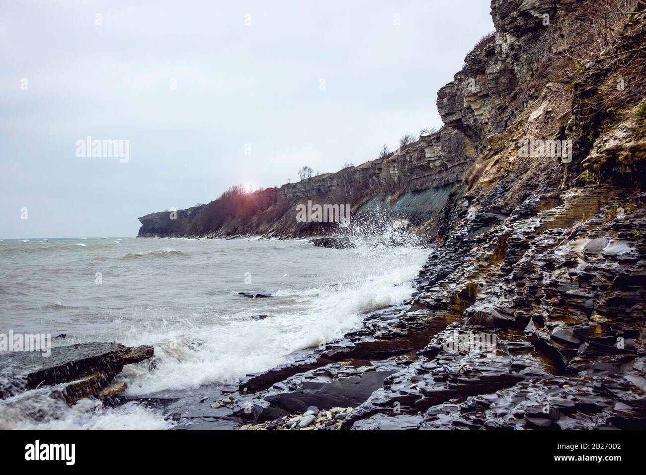 Winter storm on Baltic sea under the bank cliff. Pakri bank in Pakri peninsula near city of Paldiski in Estonia, Europe. Stock Photo