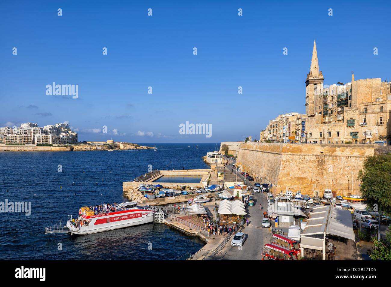 Old city of Valletta in Malta, VFS ferry boat between Valletta and Sliema in Marsamxett Harbour in the Mediterranean Sea Stock Photo