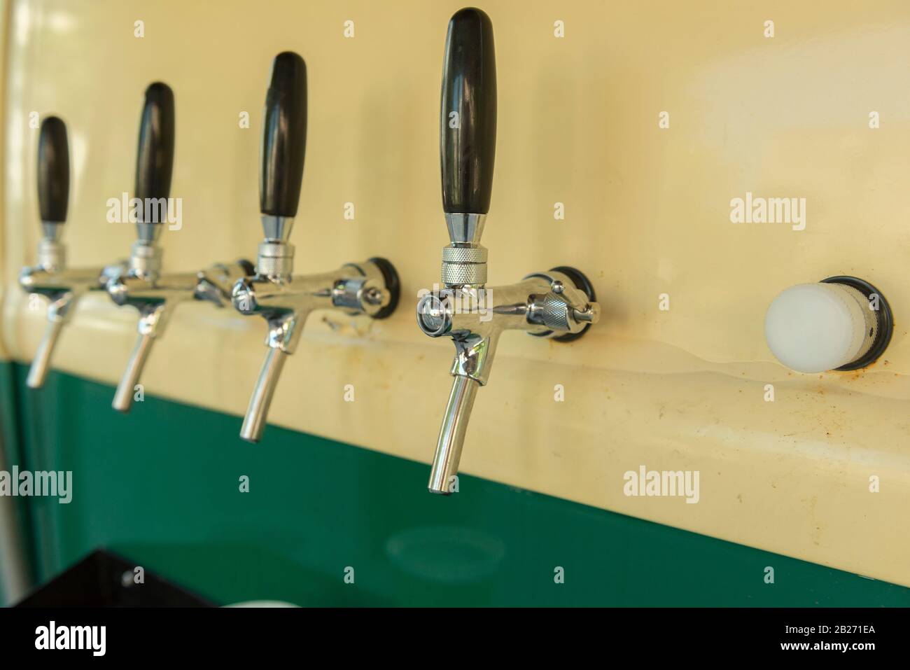 The beer taps in a side of a vintage van. nobody. Selective focus. Alcohol concept. Vintage style. Beer craft. Cold beer food truck in southern Brazil Stock Photo