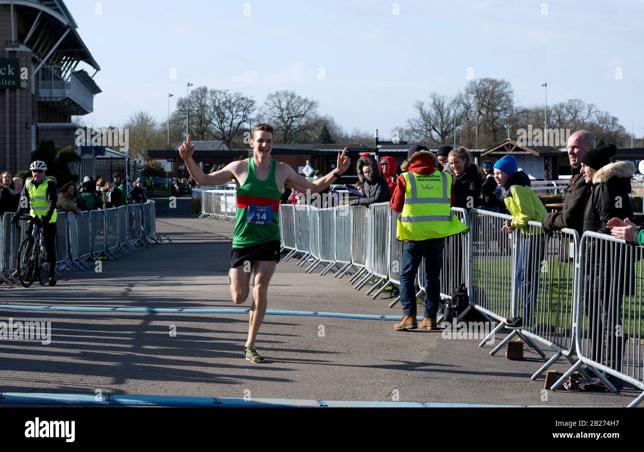 A runner winning the Warwick Half Marathon, Warwickshire, UK Stock Photo
