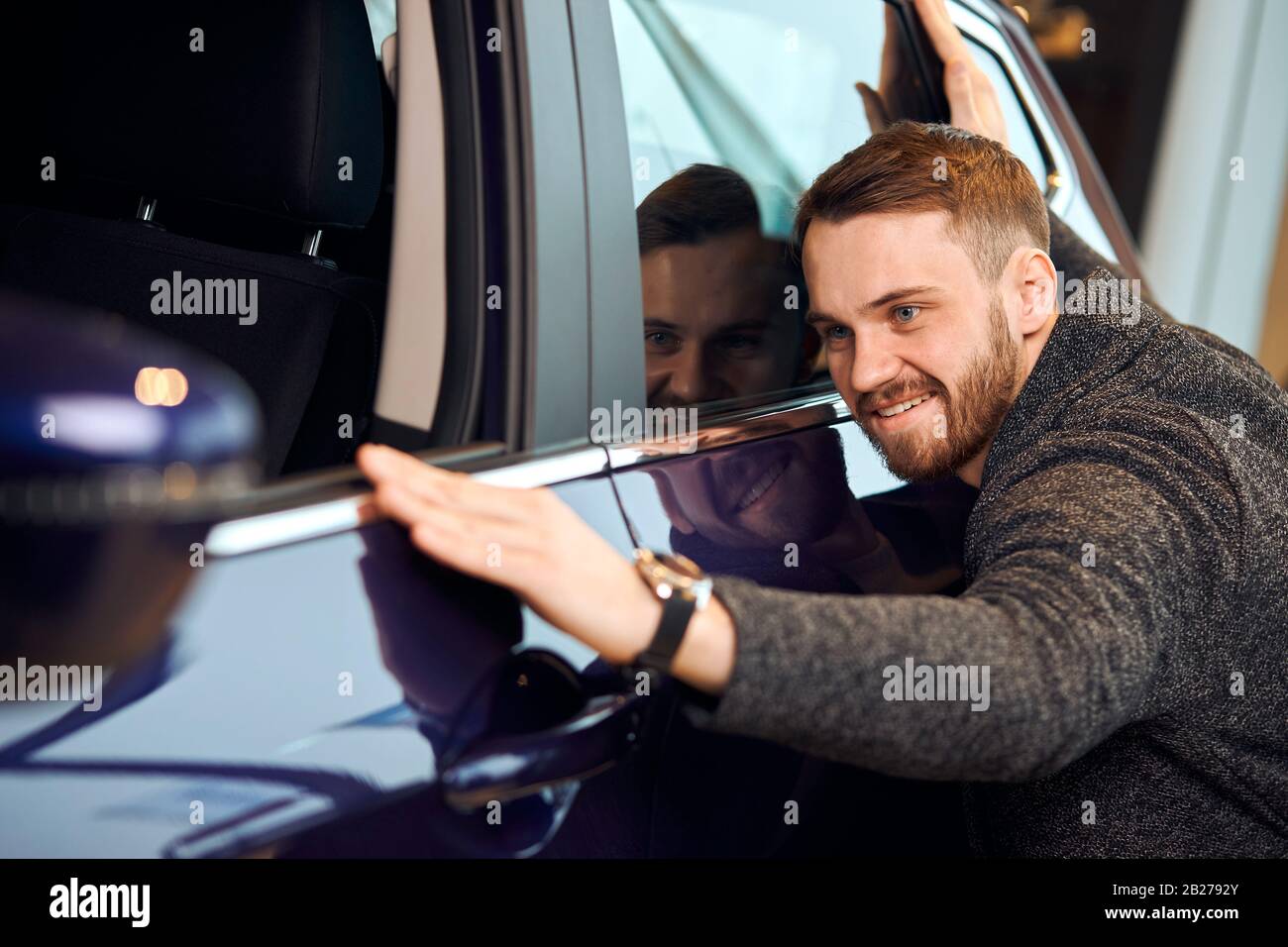 love at first sight, cheerful customer enjoying bought car, happiness,  delight, positive feeling and emotion. funny guy striking his own car ,  close Stock Photo - Alamy
