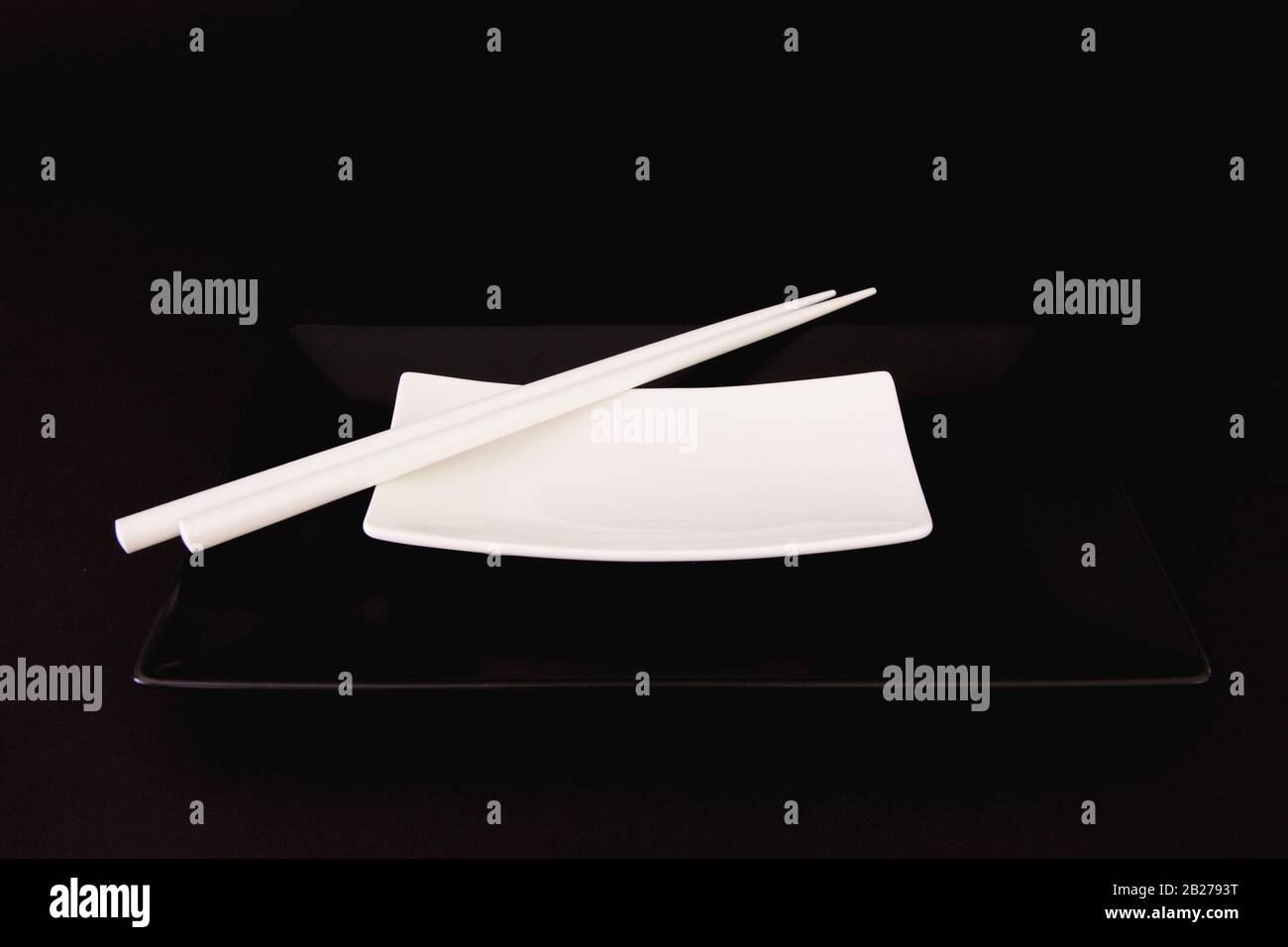 Black and White Empty Sushi Plates With White Bamboo Chopsticks. Black