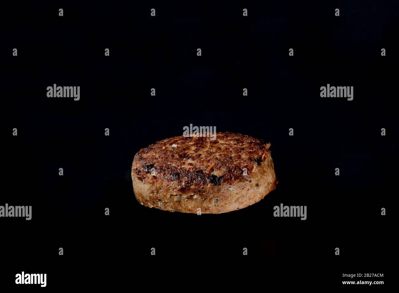 cutlet on burger on a black background Stock Photo