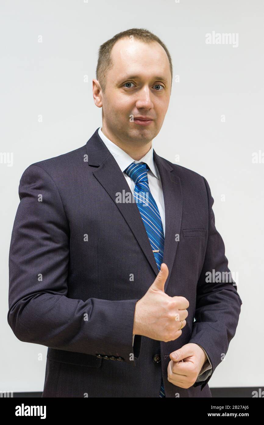 portrait of a confident, purposeful, successful businessman weared in grey suit and blue neck tie Stock Photo
