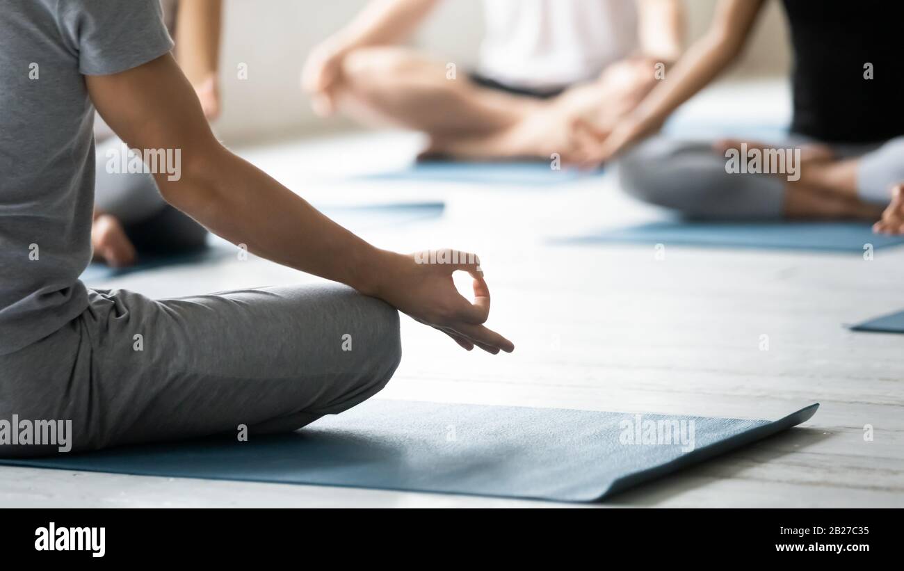 Yoga coach and session participants meditating close up concept image Stock Photo
