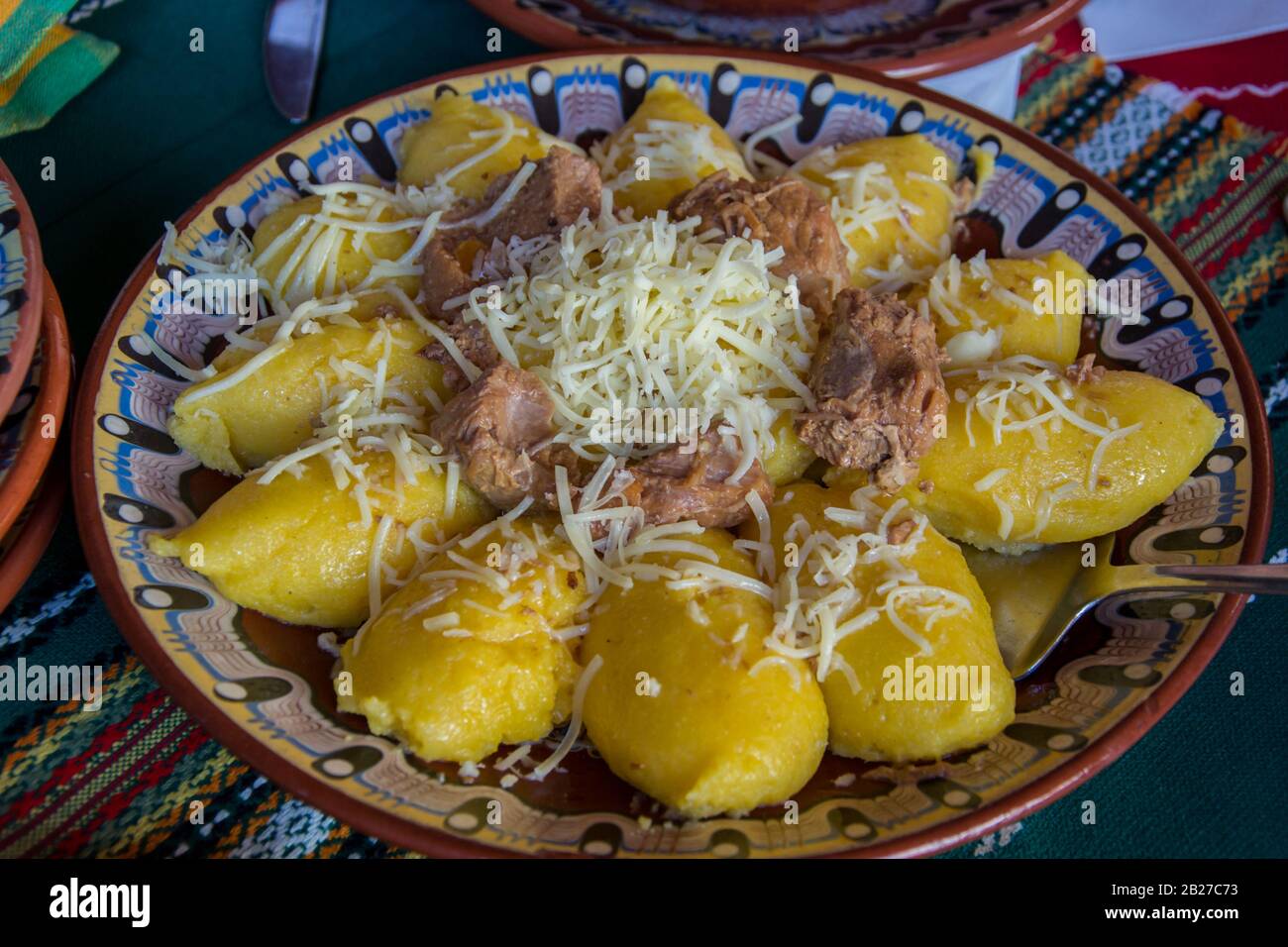 Natural food, hominy or mamaliga on a plate with grated cheese on top, traditional bulgarian meal Stock Photo