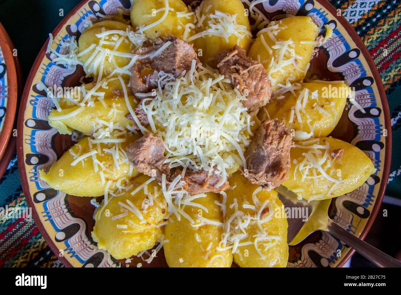 Natural food, hominy or mamaliga on a plate with grated cheese on top, traditional bulgarian meal Stock Photo