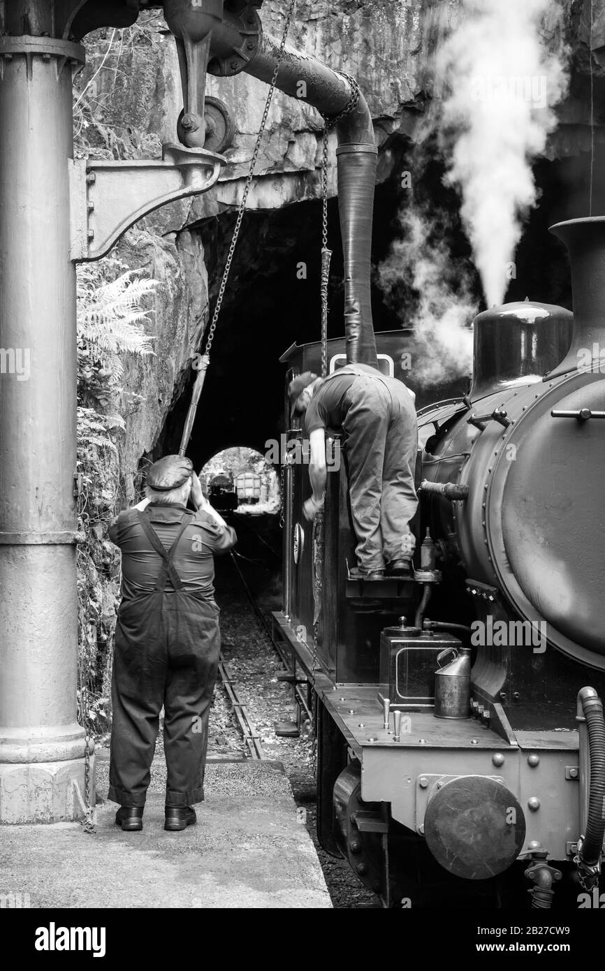 Two man work in the locomotion at Haverthwaite railway station, Lake District, UK Stock Photo