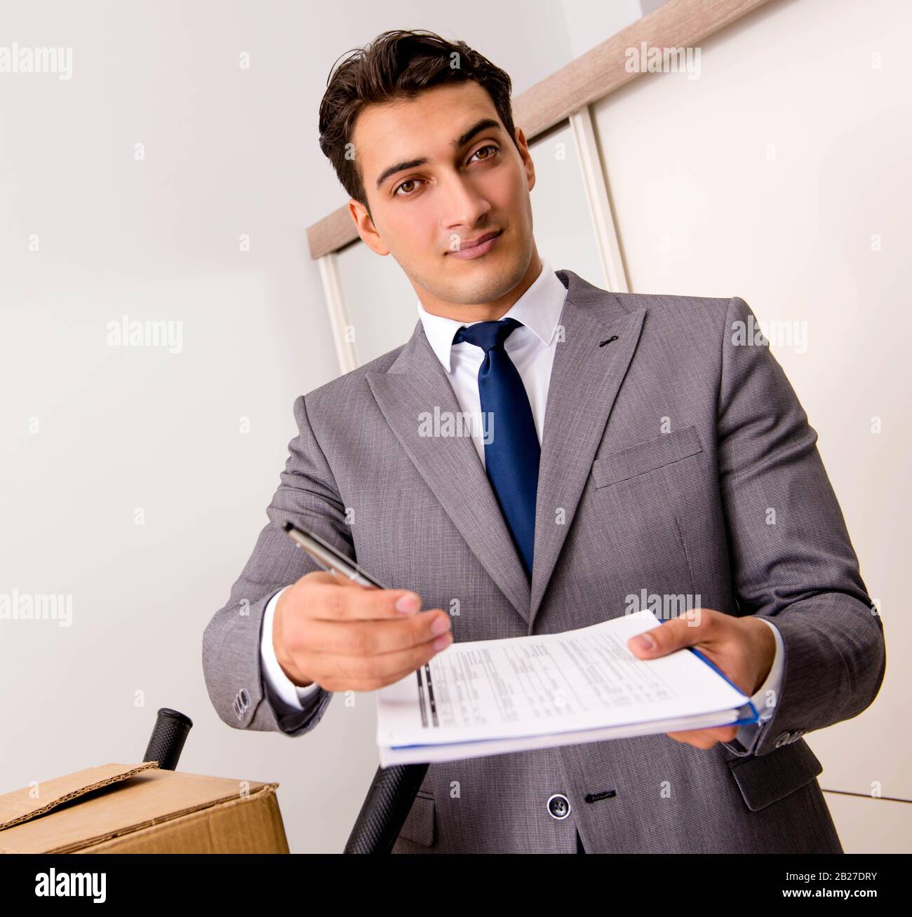 The man signing for the delivery of boxes Stock Photo - Alamy