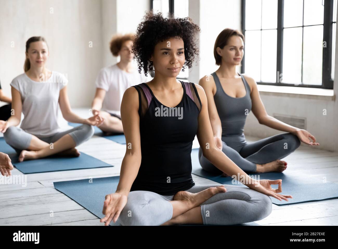 African ethnicity coach lead group training do meditation practice Stock Photo