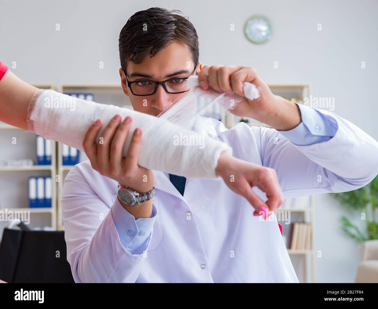 The doctor and patient during check-up for injury in hospital Stock ...