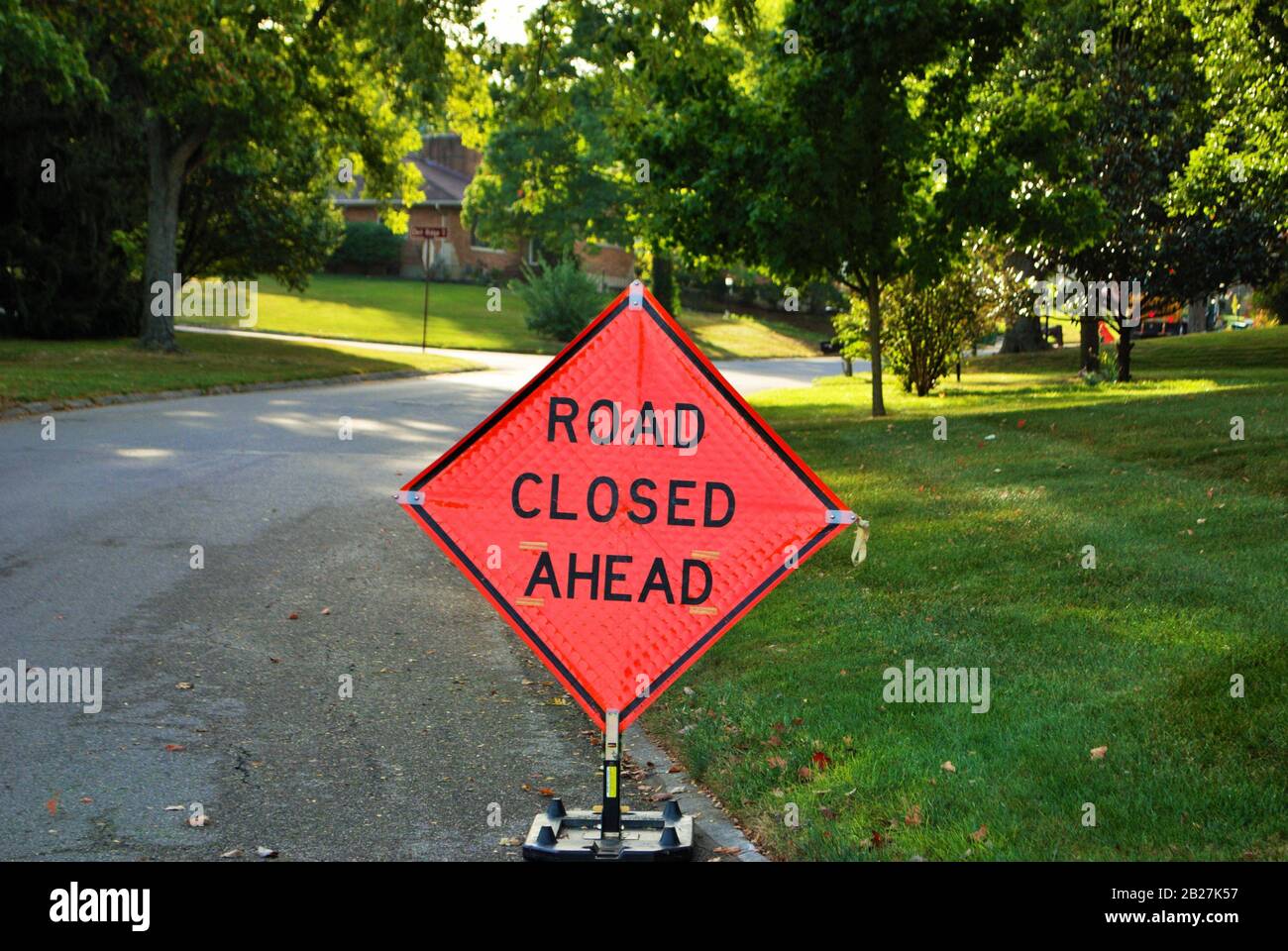 road closed ahead construction sign in a residential neighborhood Stock