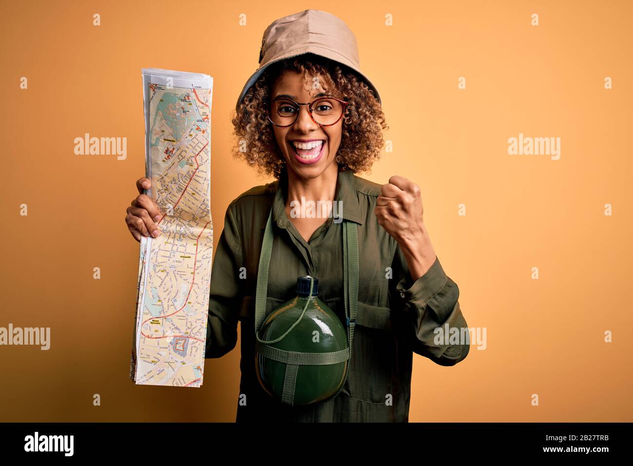 African american tourist woman wearing explorer hat and water canteen ...
