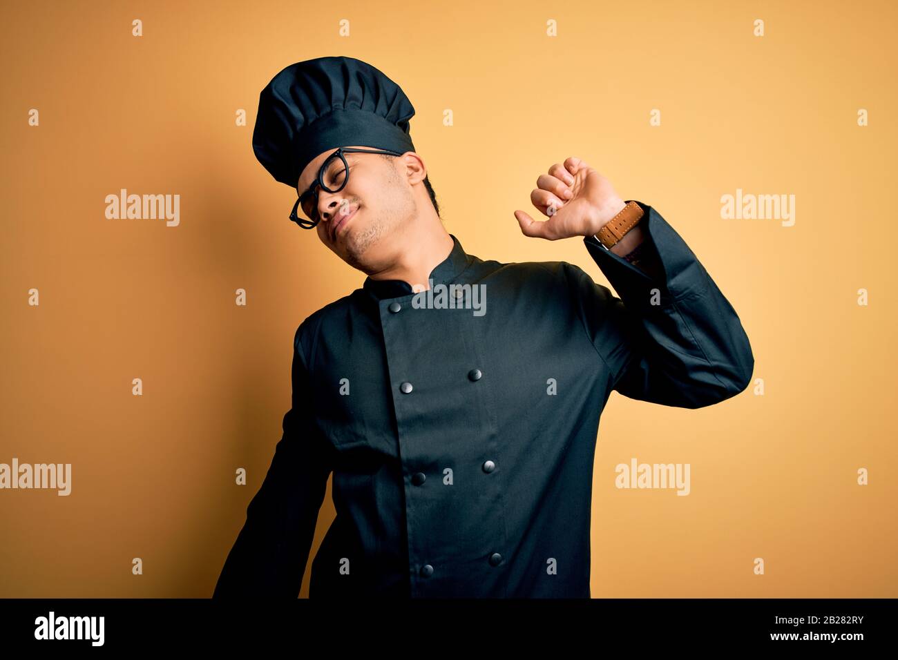 Young brazilian chef man wearing cooker uniform and hat over isolated ...