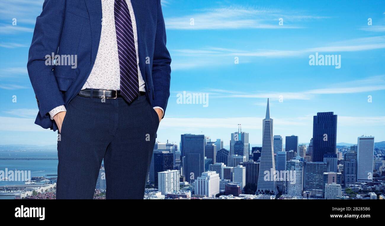 Businessman in suit with tie standing near the window of downtown, Los