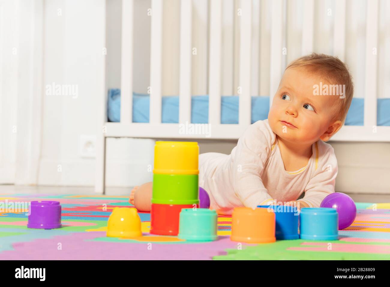 Beautiful Baby Toddler Boy Crawl In Front Of Crib Play With Toys