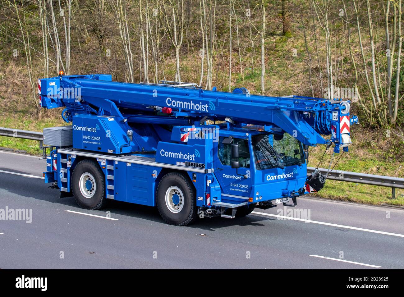 Liebherr Commhoist, 2019 blue Liebherr Ltm1040-2.1;  HGV Haulage delivery trucks, lorry, transportation, truck, cargo carrier, travelling vehicle, European commercial transport industry, M61 at Manchester, UK Stock Photo