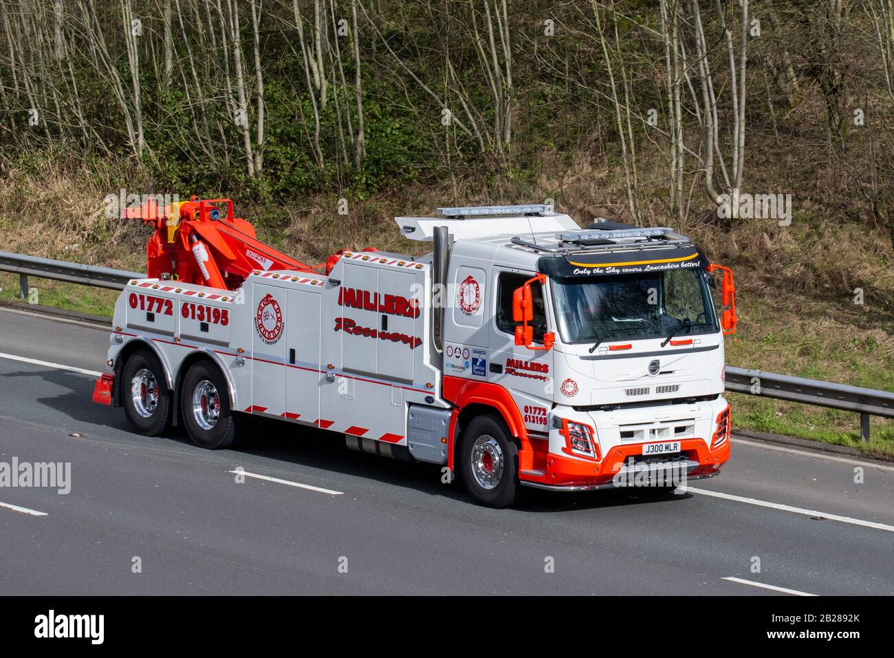 Millers recover; HGV Haulage breakdown recovery trucks, lorry, transportation, truck, cargo carrier, 2019 Volvo FM vehicle, European commercial transport industry, M61 at Manchester, UK Stock Photo