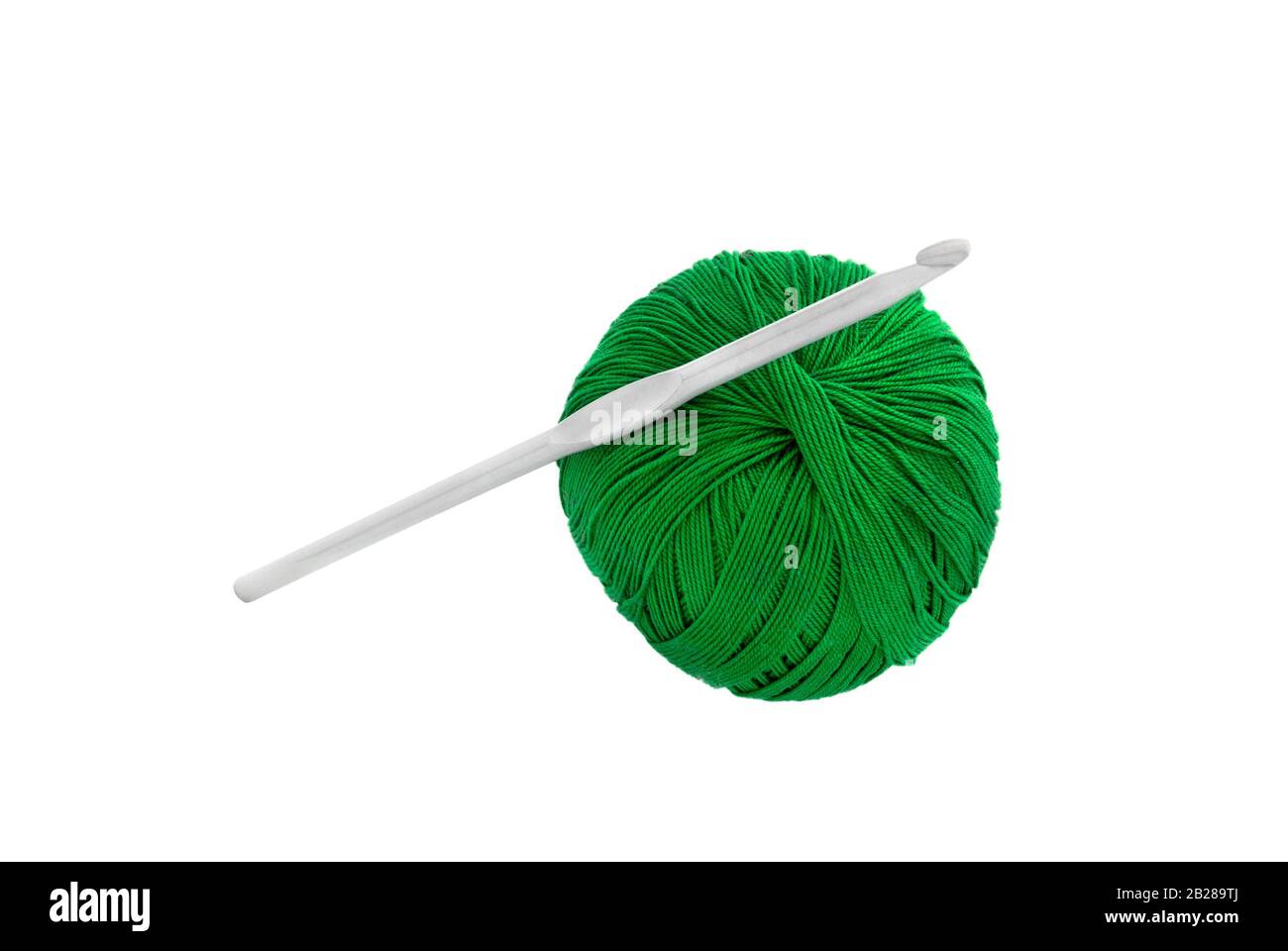 Dark green thread spool with purple crochet hook, isolated on white  background Stock Photo - Alamy