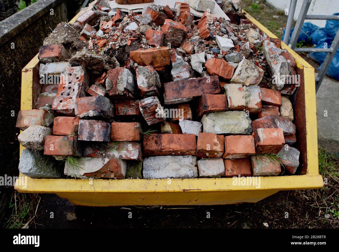 Builder's skip full of bricks Stock Photo Alamy