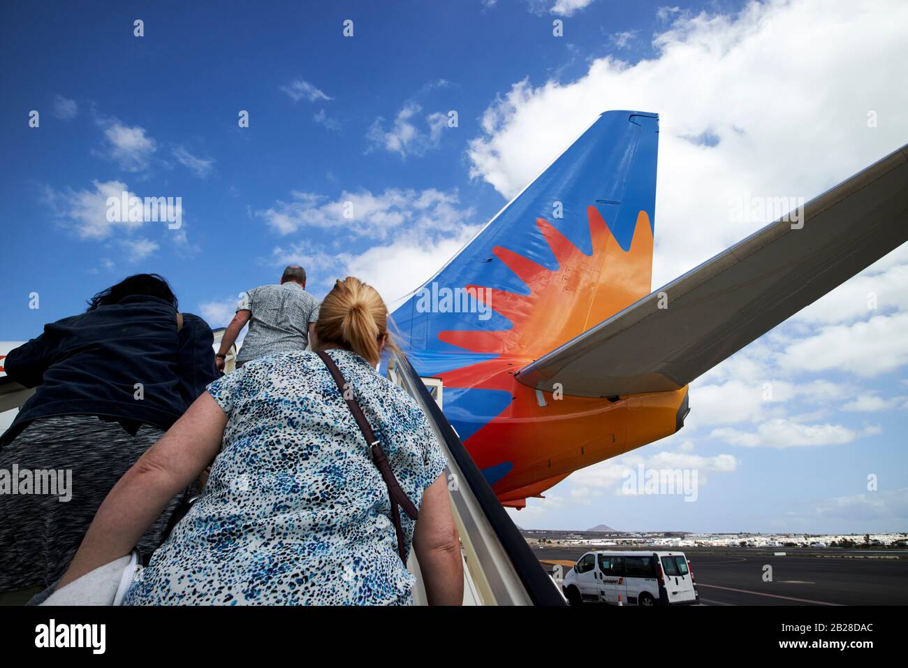 overweight female passengers walking up rear steps of jet2 aircraft g-drtg arricife cesar manrique-Lanzarote airport canary islands spain Stock Photo