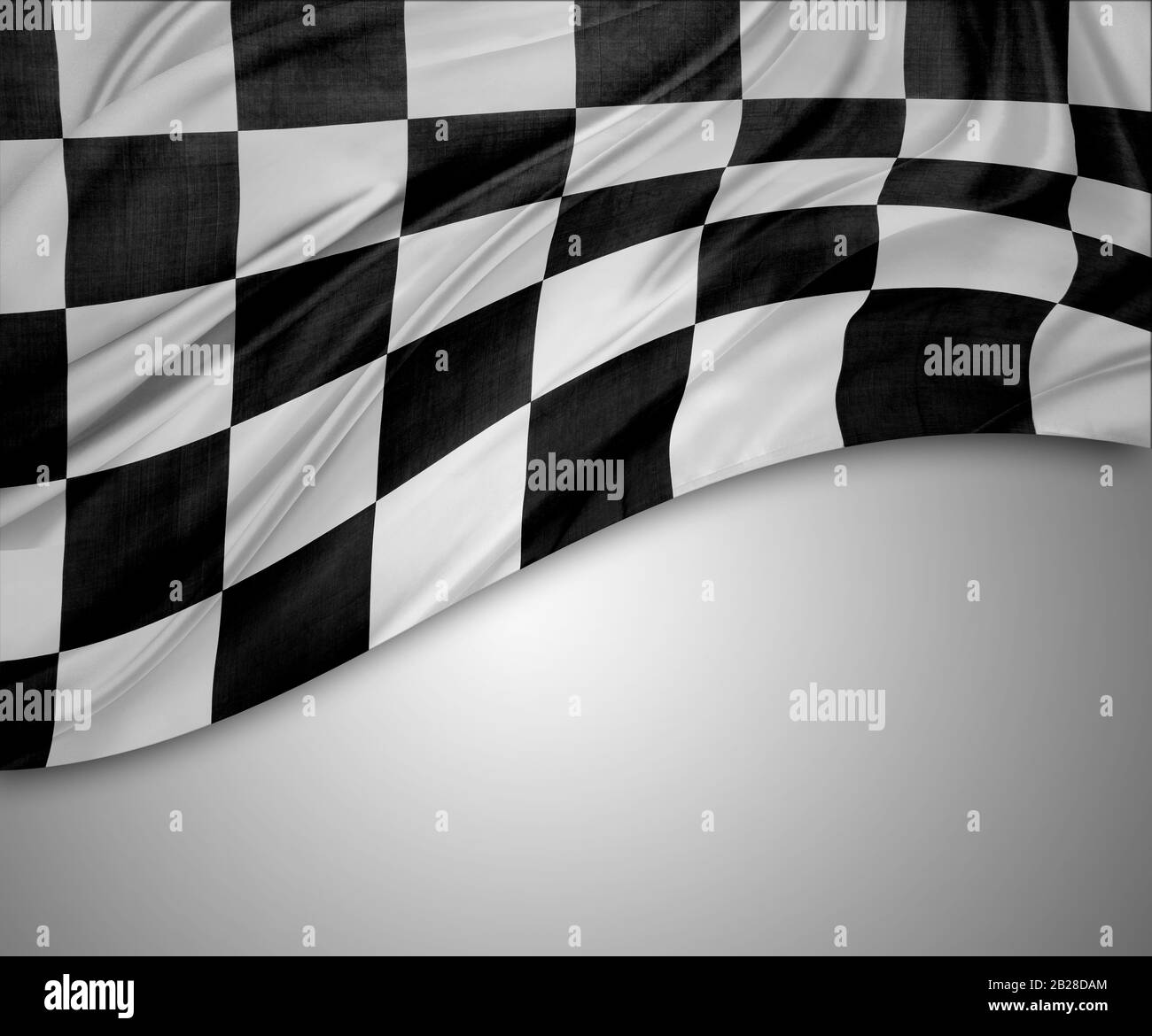 Checkered black and white flag on grey background. Copy space Stock