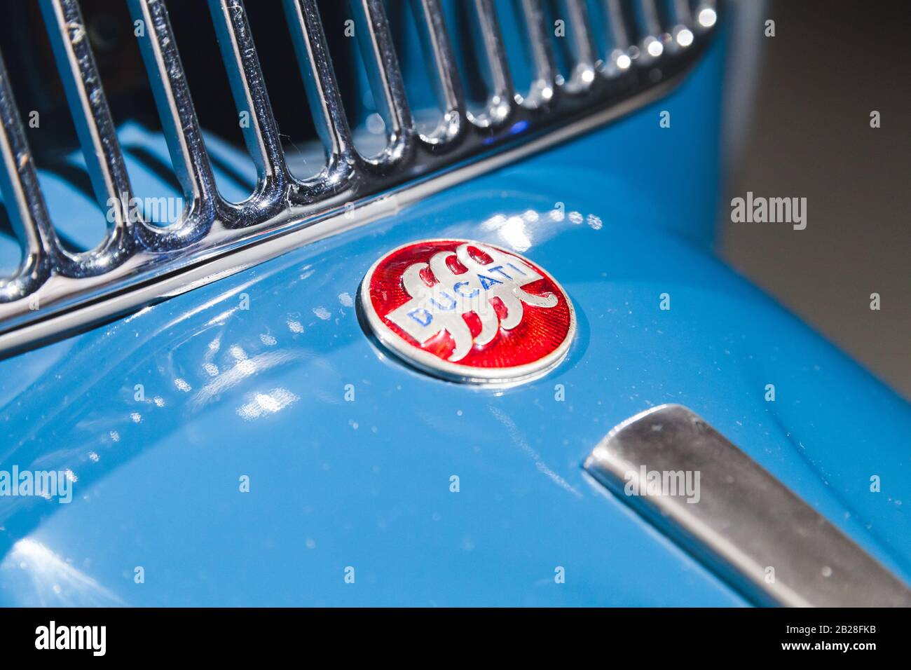 St.Petersburg, Russia - April 3, 2019: Round red Ducati sign is on Ducati cruiser 175, vintage blue scooter fragment Stock Photo