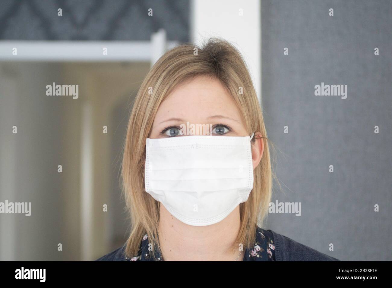European blond women with a mask to protect herself Stock Photo