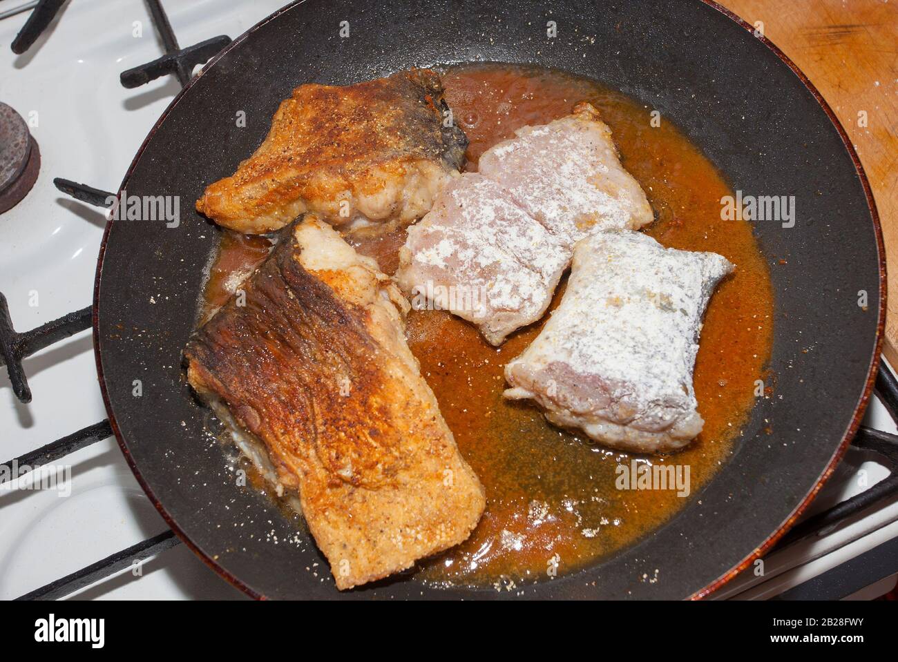 pan with fried fish in tomato sauce and oil Stock Photo Alamy