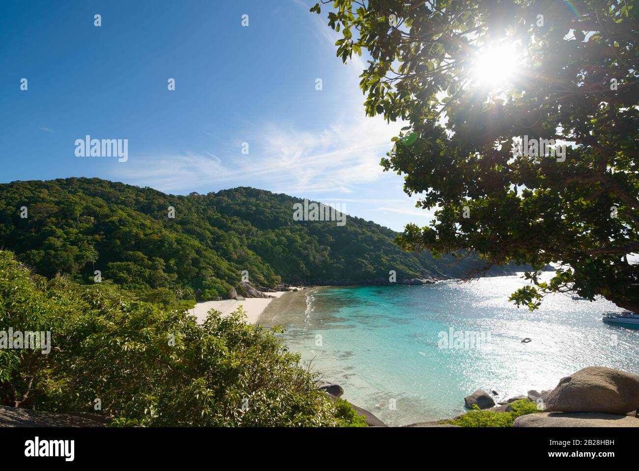 High view of Similan island Andaman sea. Beautiful white sand beach, crystal clear sea water, sun and sunrays at tropical island, top view. Similan is Stock Photo