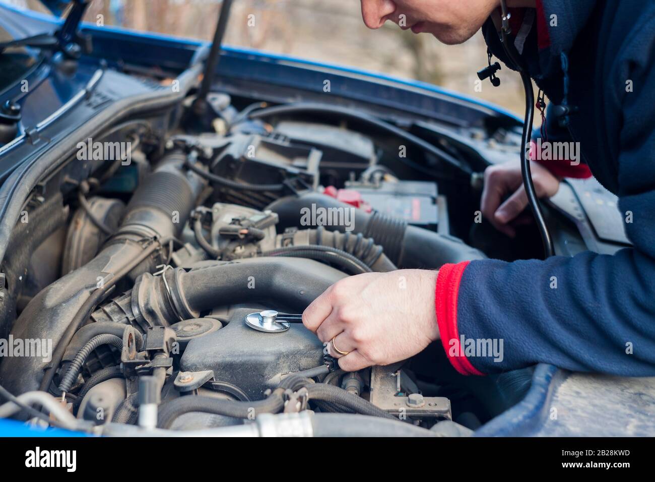 car engine check with stethoscope, abstract auto service concept Stock