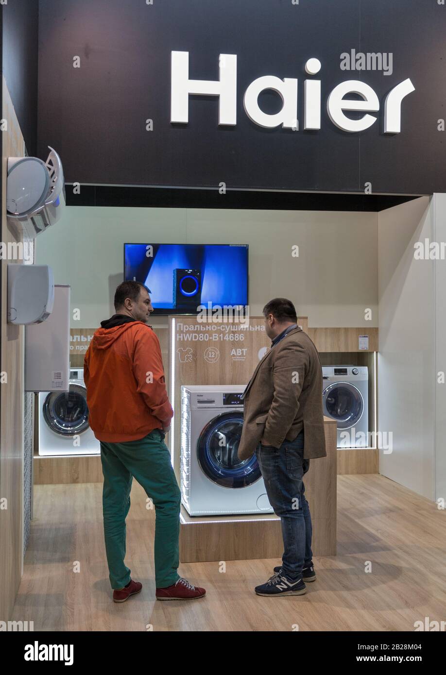 KYIV, UKRAINE - APRIL 13, 2019: People visit Haier booth, a multinational home appliances and consumer electronics company, at CEE 2019, the largest e Stock Photo