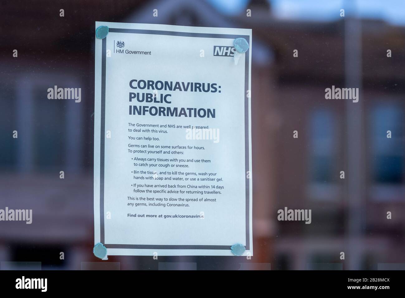 Coronavirus public information notice on window of entrance to doctors surgery in Westcliff on Sea, Essex, UK Stock Photo