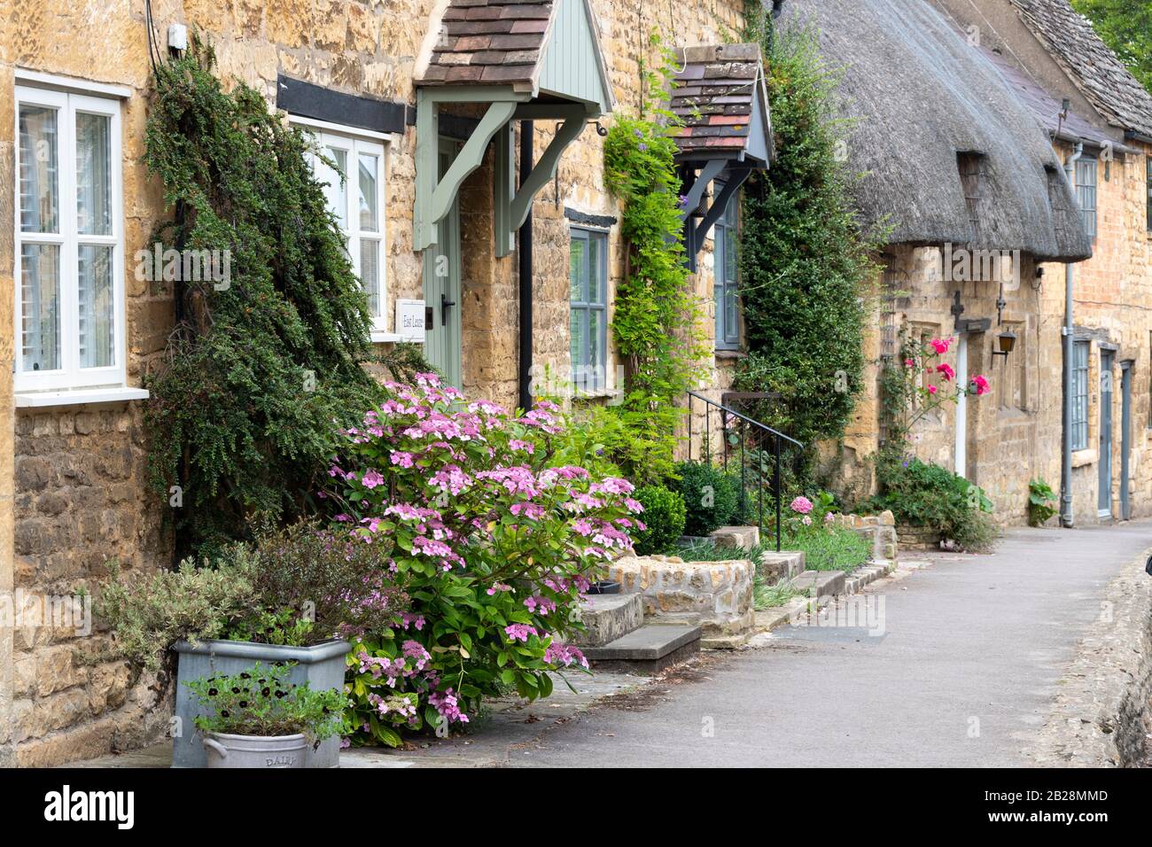 Row of houses with trees and gardens close to the steret, Chipping Campden, Gloucestershire,Cotswolds, England Stock Photo