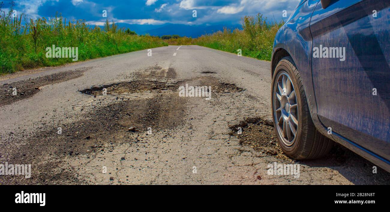car driving on bad road cracked and damaged Stock Photo Alamy