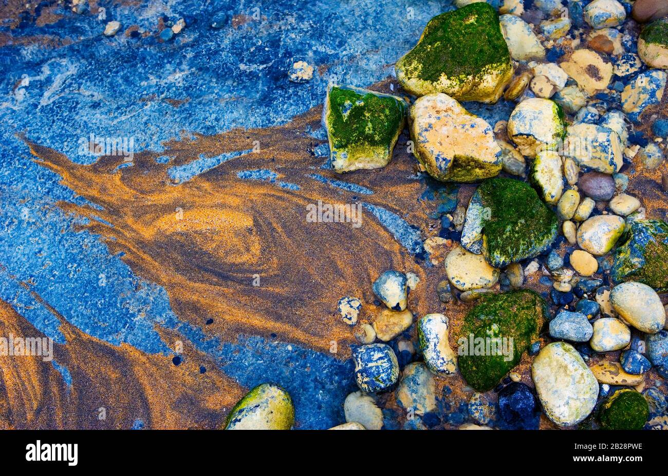 Sand and stones, coastal landscape near Burren, West coast, County Clare, Republic of Ireland Stock Photo