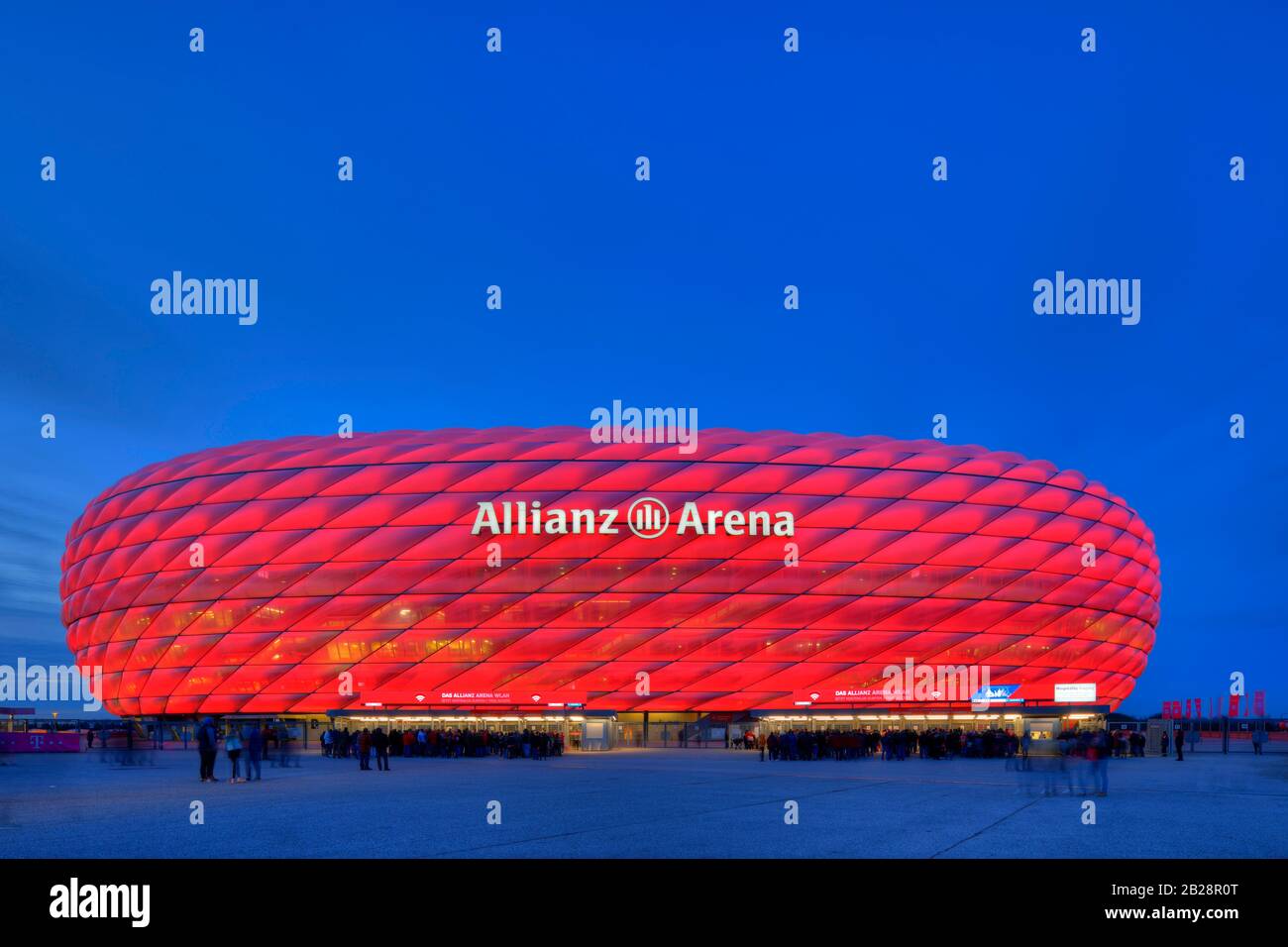 Spectators waiting for admission, illuminated Allianz Arena at the blue hour, Munich, Bavaria, Germany Stock Photo