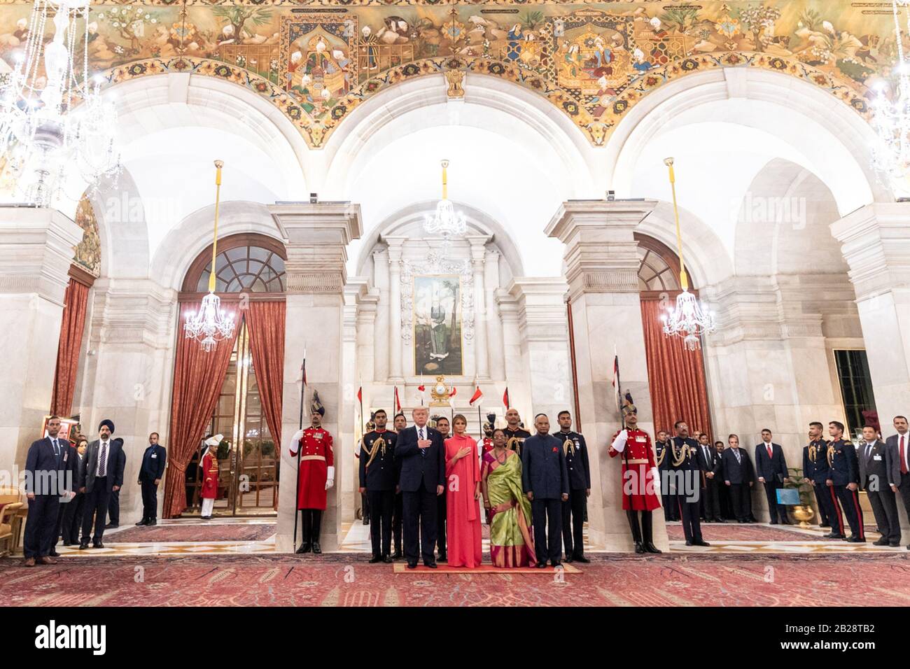 New Delhi, India. 25th Feb, 2020. President Donald J. Trump and First Lady Melania Trump, joined by Indian President Ram Nath Kovind and his wife Mrs. Savita Kovind, place their hands on their hearts while the United States National Anthem is played during a state banquet welcome ceremony Tuesday, Feb. 25, 2020, at Rashtrapati Bhavan, the Presidential Palace, in New Delhi, India. People: President Donald J. Trump, First Lady Melania Trump Credit: Storms Media Group/Alamy Live News Stock Photo