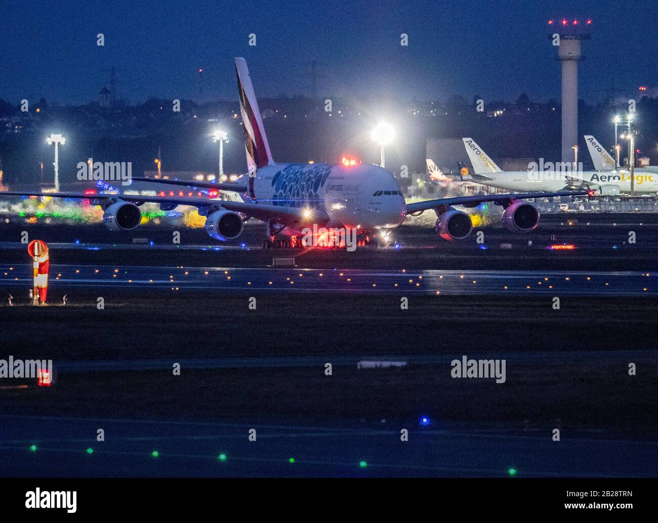 01 March 2020, Hessen, Frankfurt/Main: An Emirates Airbus A-380 rolls to its parking position at Frankfurt Airport after dark. The aviation industry is already feeling the effects of the spread of corona virus. Experts expect massive losses for the airlines. Photo: Boris Roessler/dpa Stock Photo