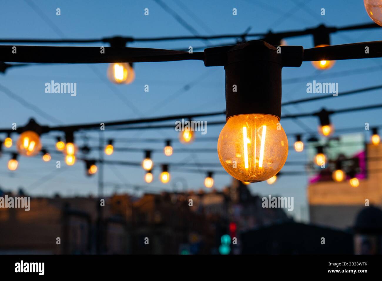 Light bulbs on the evening blue sky. Stock Photo