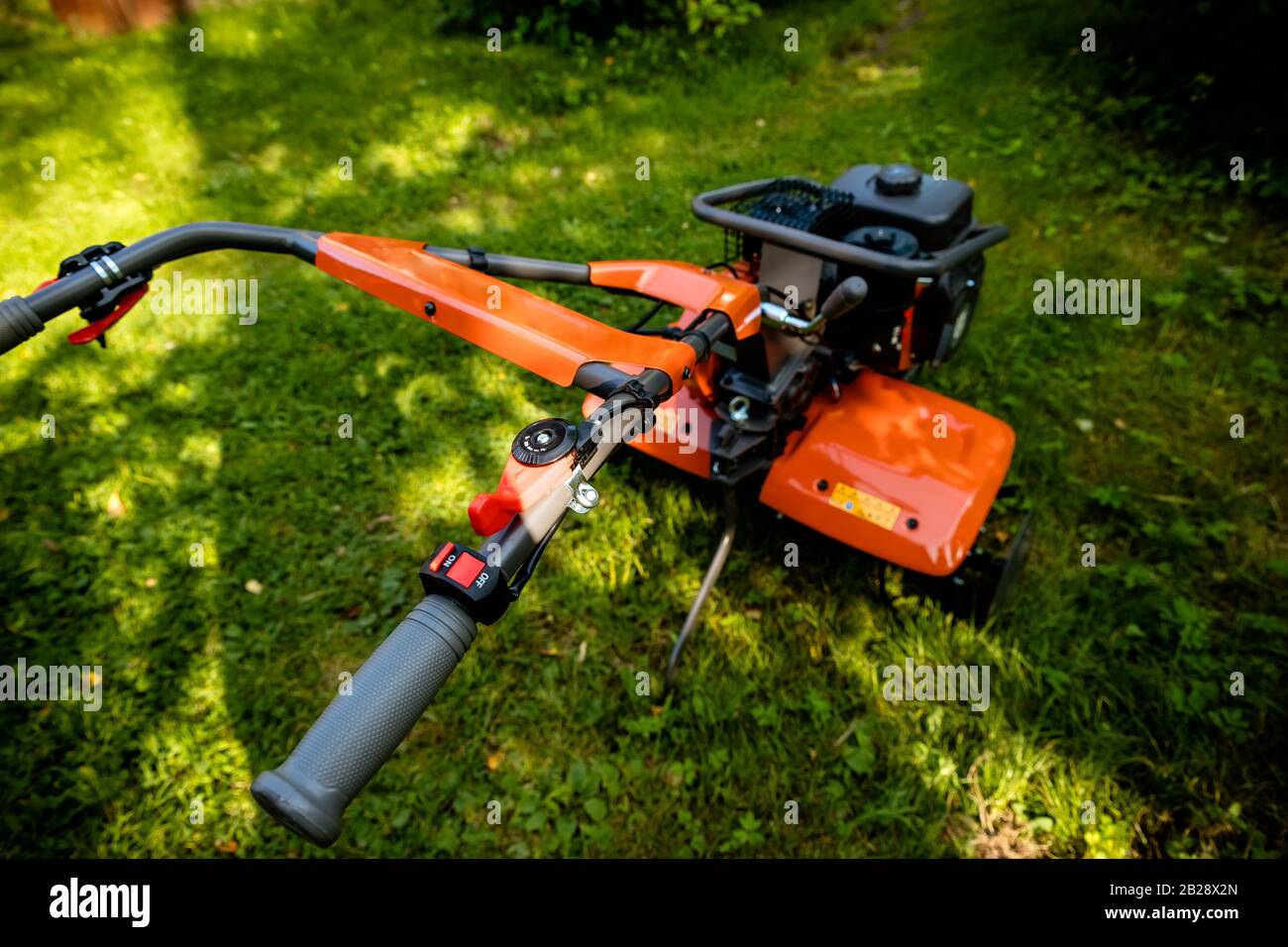 garden with tiller machine. Garden tiller to work, close up.Abstract