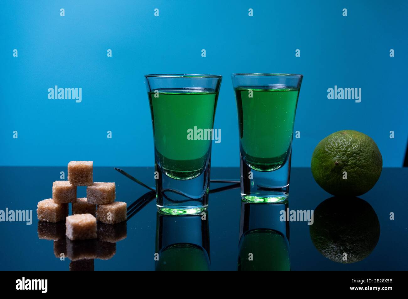 Absinthe, lime and sugar. Making a cocktail with absinthe Stock Photo ...